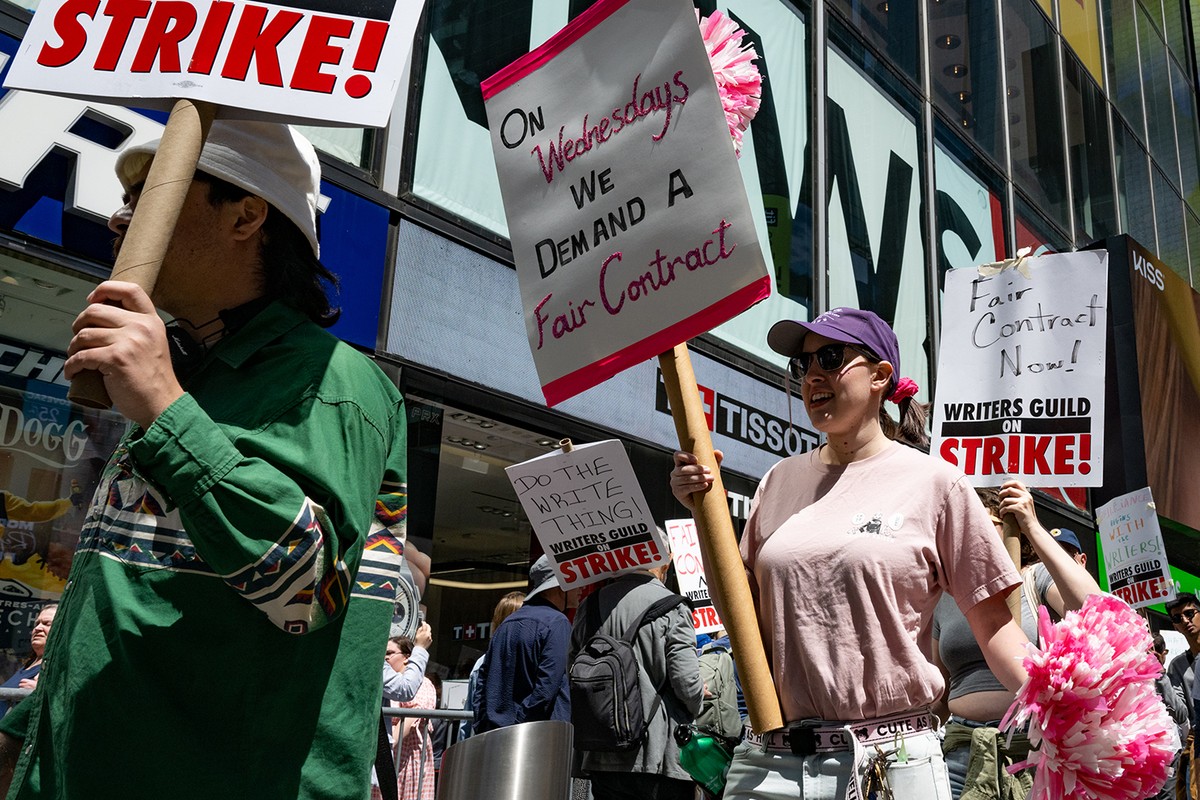 Writers Guild of America (WGA) East members walk a picket line at the Paramount+ Summit outside the Paramount Building in Times Square