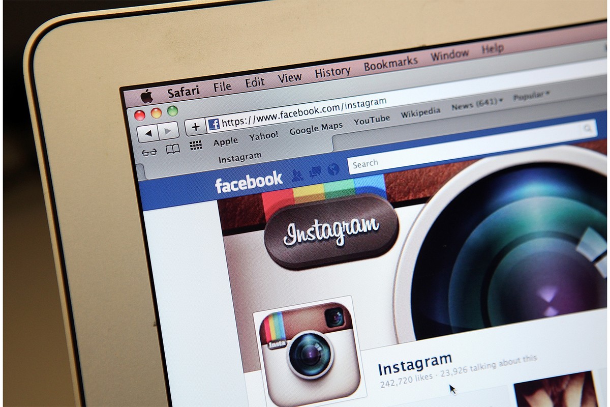 A laptop shows a browser window opened up to Instagram's business page hosted on Facebook